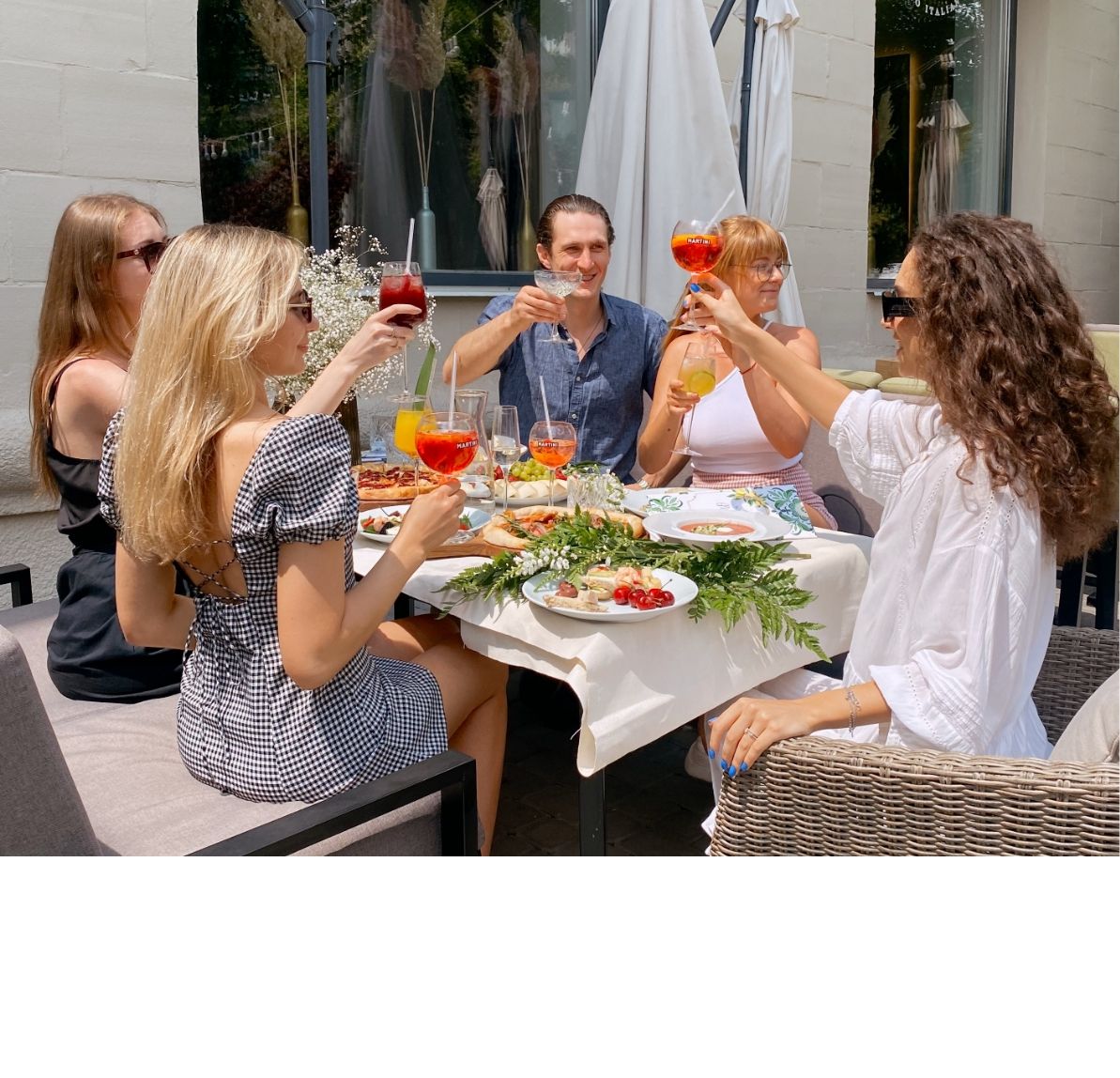 friends enjoying a meal on a restaurant patio